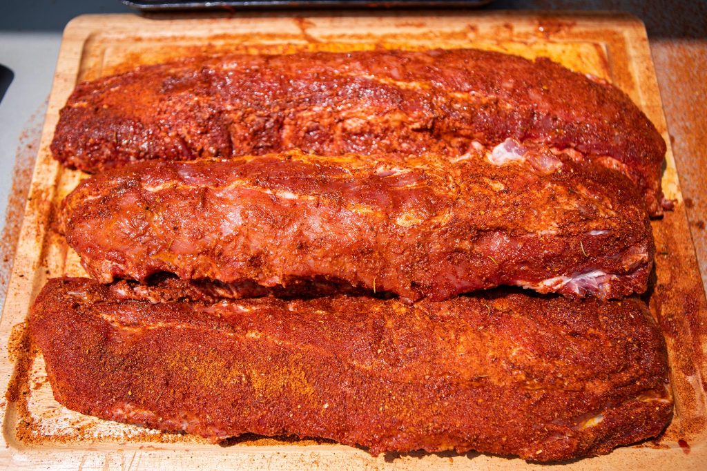 Baby Back Ribs Coated with Meadow Creek Brisket Rub and Gourmet Seasoning Breaking in the Meadow Creek BX25 Box Smoker