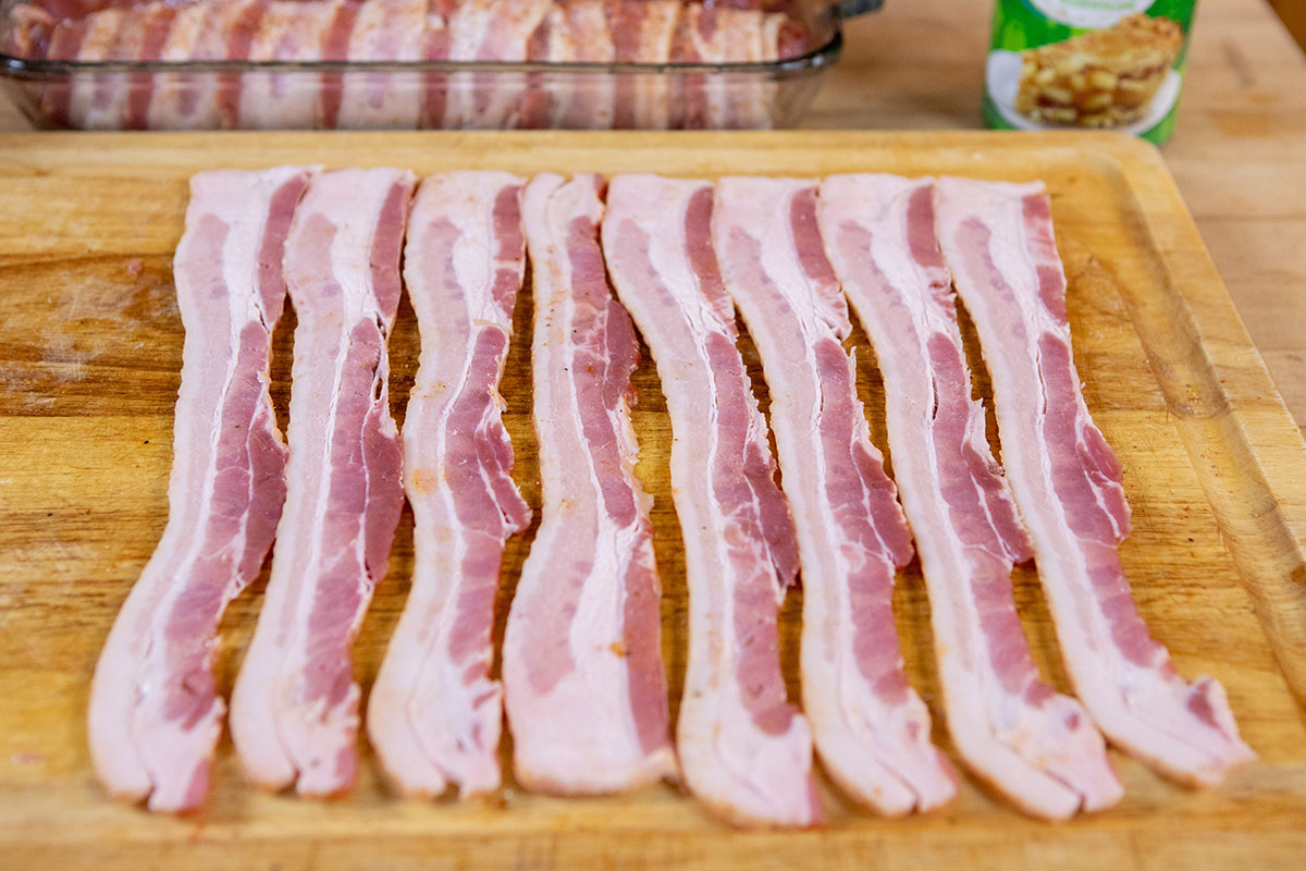 Arrange 8 pieces of bacon Bacon-Wrapped Apple-Stuffed Tenderloin on the Big Green Egg