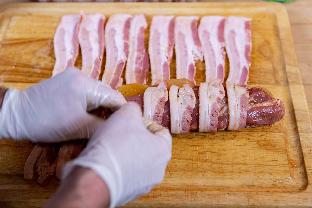 Wrap the bacon Bacon-Wrapped Apple-Stuffed Tenderloin on the Big Green Egg