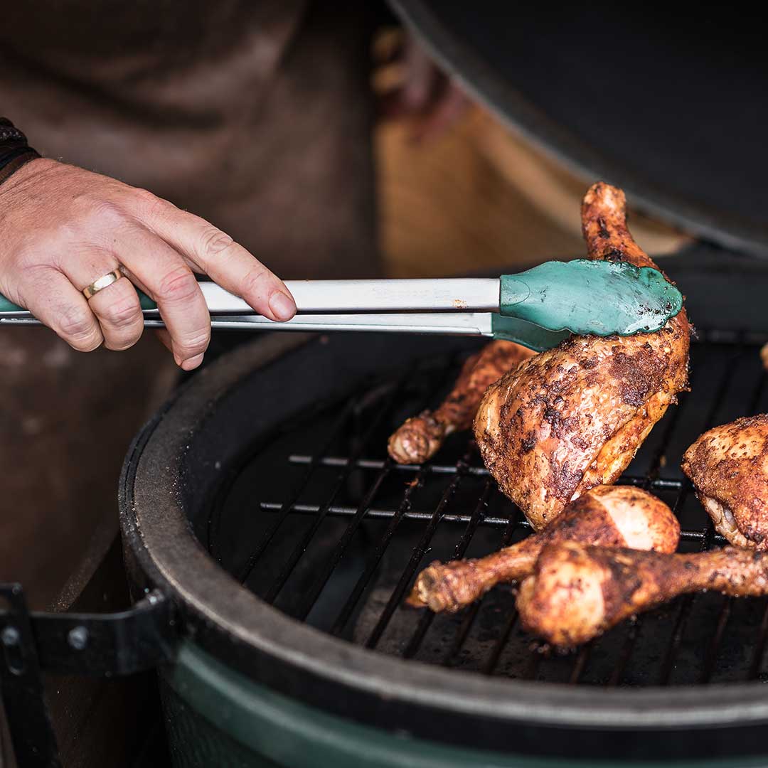 https://www.meadowcreekbbqsupply.com/wp-content/uploads/2021/11/Big_Green_Egg_Stainless_Steel_Silicone_Tipped_BBQ_Tongs_Chicken_on_Big_Green_Egg.jpg