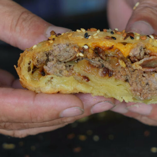 Finished bacon burger bomb sliced open to show interior