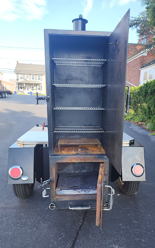 Used Meadow Creek TS120 Tank Smoker With Live Smoke, Insulated Firebox, Stainless Steel Exterior Shelves & Extra Grate in Warming Box